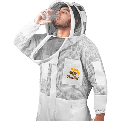 Man wearing a protective beekeeper suit drinking water through the open zipper of his hoodie